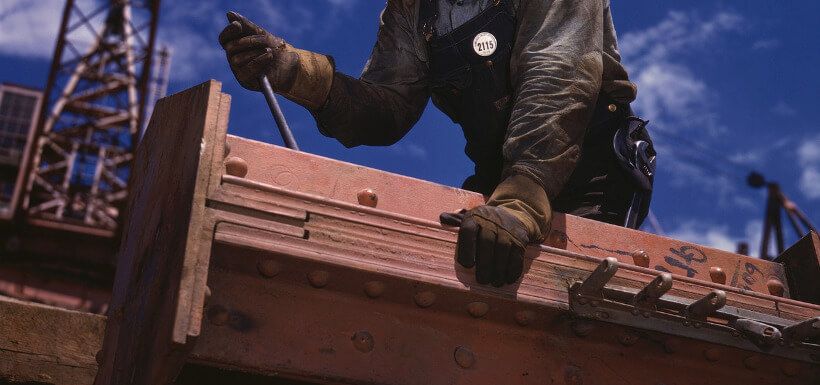 Bauarbeiter arbeitet an Stahlträger