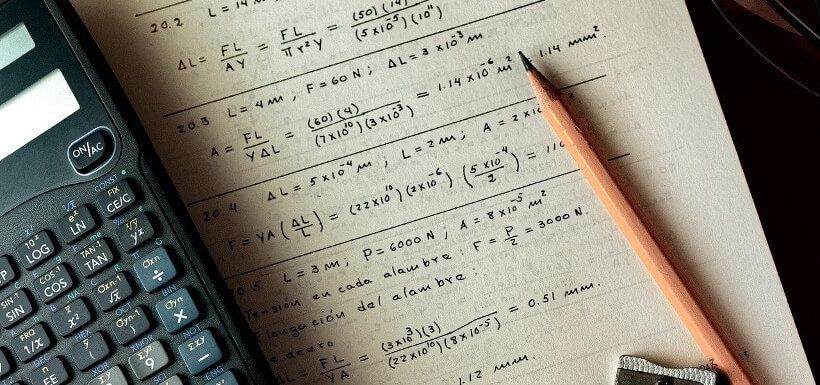 Taschenrechner, Papier mit mathematischen Gleichungen, Bleistift, Spitzer